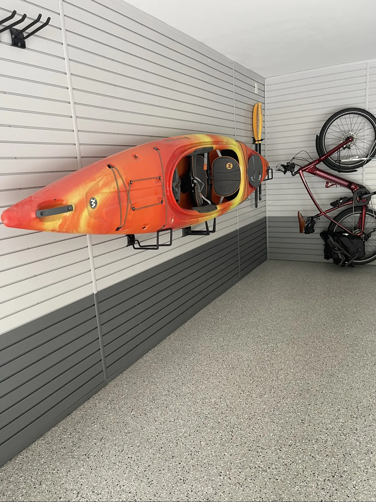 Bright finished garage with kayak on slatwall